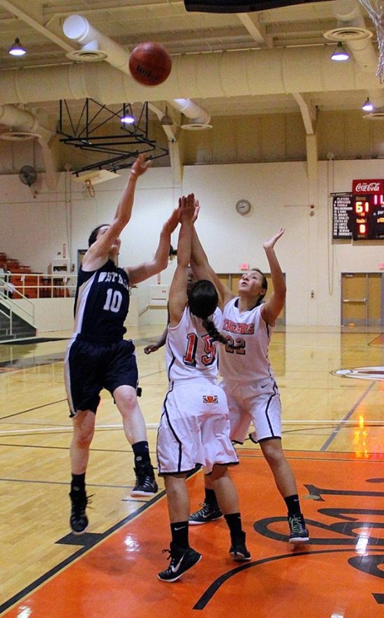 Kim Alfors provided the winning points in a 62-61 win over Reedley Saturday night. Here she is shown making the winning shot.